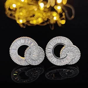 Macro detail of silver double ring earrings featuring baguette-cut cubic zirconia stones