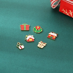 Macro shot of assorted Christmas themed enamel charms including gift boxes and houses