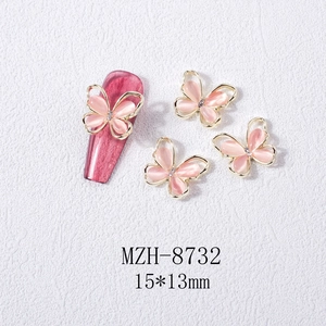 Detail of 3D opal butterfly nail charms with gold alloy frame and sparkling rhinestones