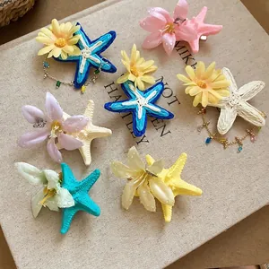 Chic fabric flower and raffia starfish hair clips in multiple colors for seaside vacation
