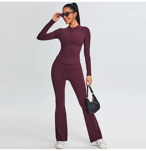 Detailed close-up of dark purple flared yoga pants with a V-shape high waist design