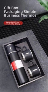 Business gift set with matte black vacuum flask and two cups in premium packaging