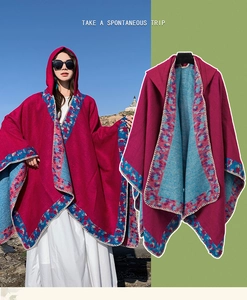 Close-up of ethnic hooded knit poncho with rose red and lake blue contrast patterns