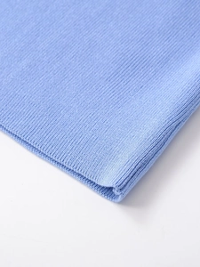 Detailed macro view of the light blue ribbed knit texture and soft stitching on the sleeve