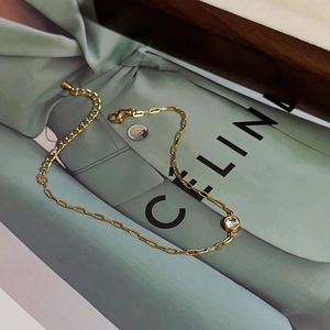 Detail of 18k gold plated bracelet with cubic zirconia and lobster clasp with chain