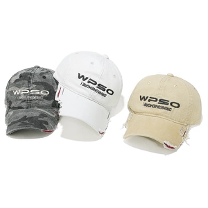 Close-up of distressed baseball caps with vintage embroidery and worn edge details
