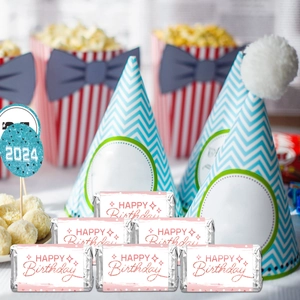 Blue birthday hat and red striped popcorn boxes with pink glitter candy bar wrappers