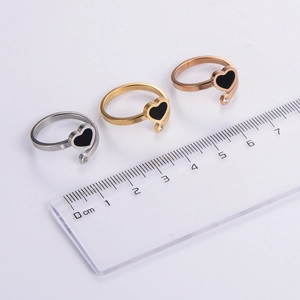 Three-piece stainless steel heart rings in gold, silver, and rose gold with black enamel