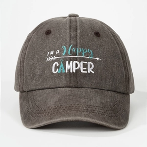 Detail of I'm A Happy Camper embroidery on a washed dark gray cotton baseball cap