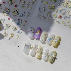 Detailed macro view of 3D embossed nail stickers featuring fairy and tulip motifs