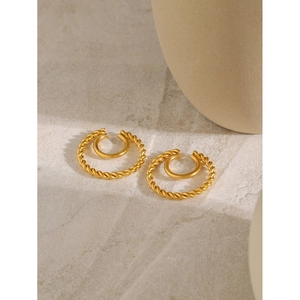 18k gold plated stainless steel double hoop twisted ear cuffs on minimalist stone surface