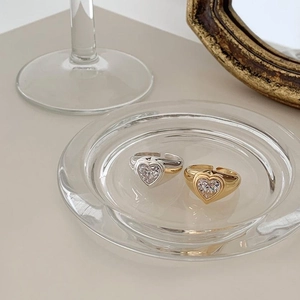 Detail of chunky gold and silver adjustable rings with heart-shaped zircon stones