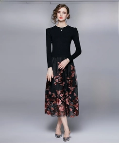 Close-up of vintage embroidery and floral mesh patchwork on a long-sleeve black dress
