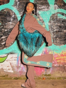 Detail of teal faux fur heart-shaped crossbody bag with fluffy texture in Y2K style