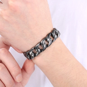 Close-up of a 15mm dark grey Cuban link titanium steel bracelet worn on a wrist