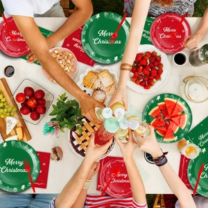 Close-up of festive Christmas party tableware set with red and green plates and napkins