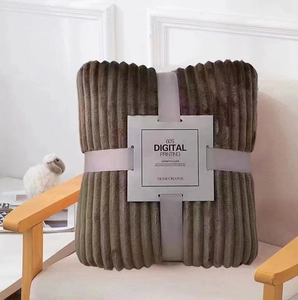Detail of dark khaki flannel blanket with vertical stripes, gift-wrapped with a grey strap