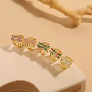 Macro detail of multi-layer 14K gold plated rings with colorful zircon inlay settings