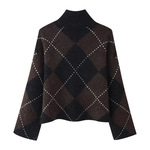 Detail of argyle knit sweater showing dark coffee and black diamond pattern and texture