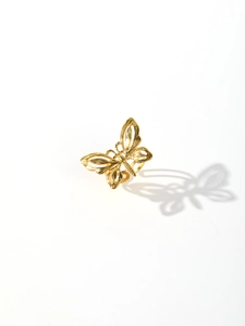 Close-up of a gold butterfly ring with vintage French style and polished metal finish