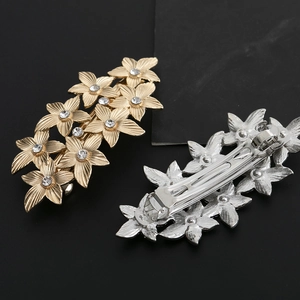Luxurious metal flower hair clips in gold and silver finish with sparkling rhinestones