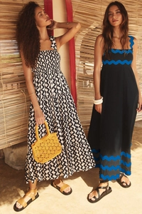 Detail of layered black and white wave print maxi dress with woven yellow handbag