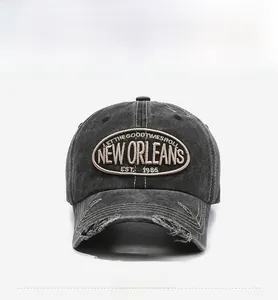 Detail of distressed brim and New Orleans embroidery on washed cotton baseball cap