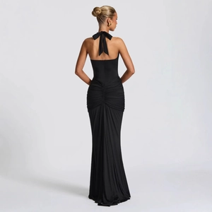 Detailed view of the back bow tie and ruched texture on this elegant black halter dress