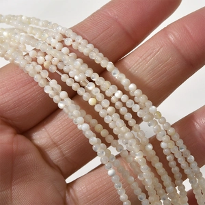 Macro shot of 2mm natural white mop shell round beads for DIY jewelry making