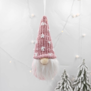 Detail of pink knitted Christmas gnome ornament with white beard and hanging rope