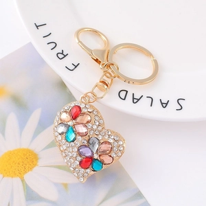 Macro detail of heart crystal keychain with multicolored gemstones and gold lobster clasp