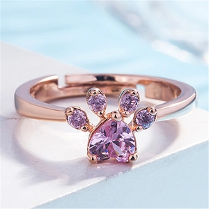 Close-up of rose gold cat paw ring with pink heart-shaped cubic zirconia gemstone