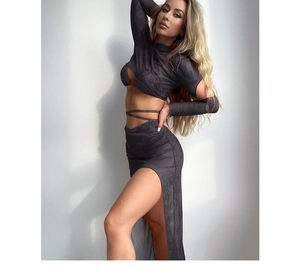 Detail of grey marbled two-piece swimsuit with long sleeve cutout top and side slit maxi skirt