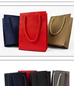 Macro shot of assorted colorful gift paper bags with reinforced nylon woven handles