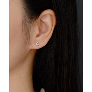 Macro detail of S925 sterling silver V-shaped screw piercing stud with cubic zirconia stones