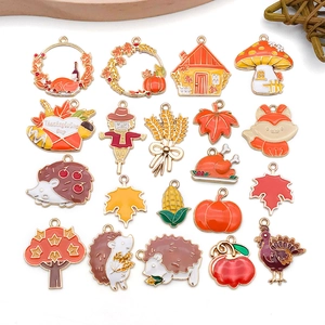 Macro detail of various colorful enamel Thanksgiving charms including pumpkin and turkey