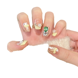 Handmade press-on nails with bow, pearls and green heart diamond in cream yellow