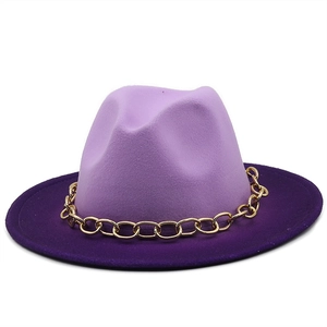 Detail of a two-tone purple wool felt fedora featuring a chunky gold metal chain link band