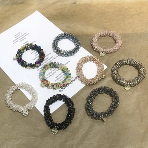 9-piece set of crystal beaded elastic hair ties with gold charms in various colors