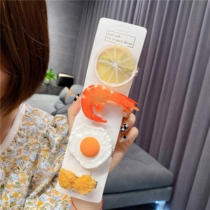 Detailed close-up of realistic 4-piece food hair clip set with lemon and shrimp designs