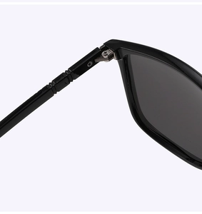 Detailed macro view of the reinforced metal hinge on black polarized sport sunglasses