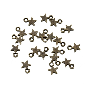 Detailed macro view of vintage bronze alloy star charms for DIY jewelry crafting