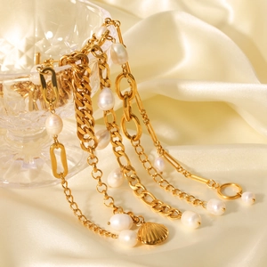Detailed close-up of golden freshwater pearl bracelets on beige silk with crystal accents
