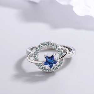Elegant silver planetary ring with blue star crystal and shimmering diamond halo