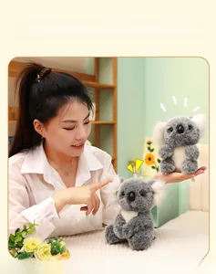 Close-up of a soft plush koala toy being held, showing fluffy texture and cute features