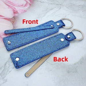 Front and back details of blue sequin 8mm metal keychain with silver rivet hardware