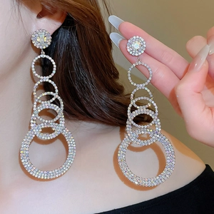 Macro shot of silver multi-layered interlocking hoop earrings with sparkling rhinestones