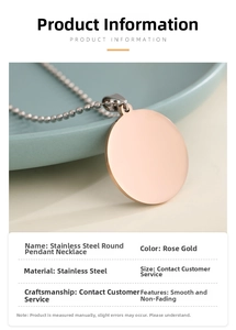 Detailed view of polished rose gold stainless steel round pendant on a ball chain