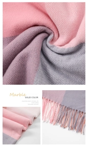 Close-up of soft pink and purple striped scarf with tassel details and woven texture