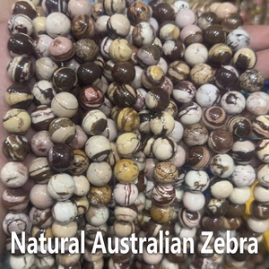 Detailed close-up of natural Australian zebra stone round beads for DIY jewelry making
